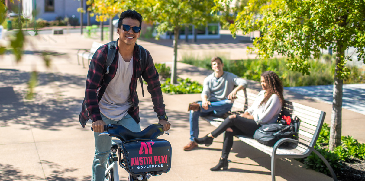 Student riding a bike downtown
