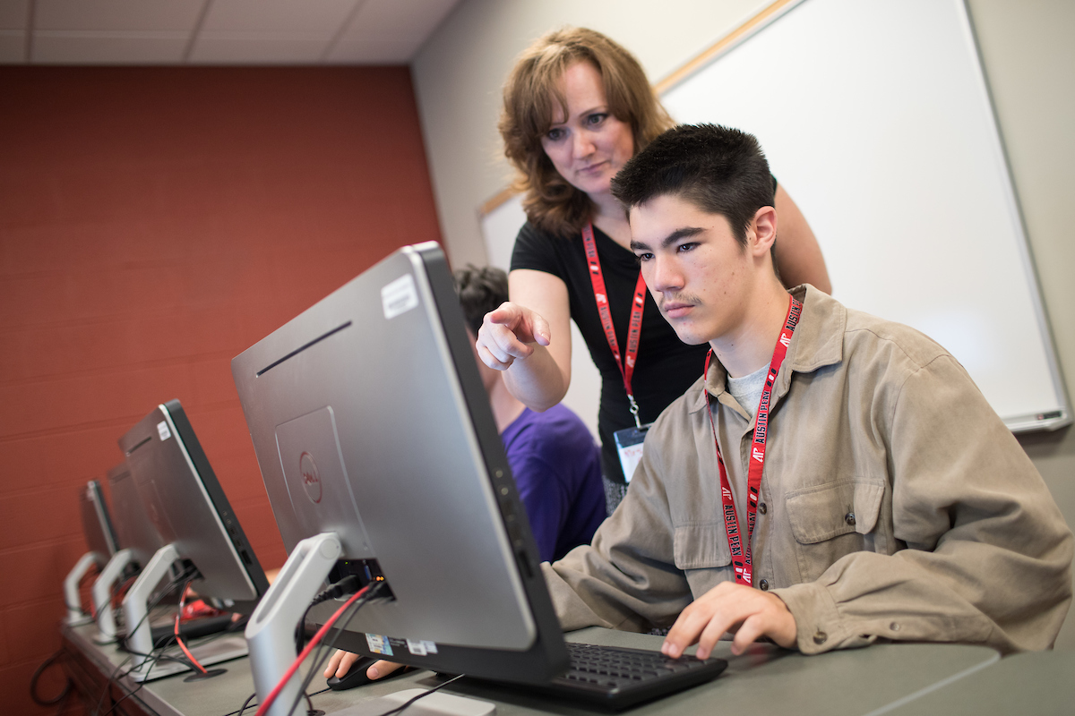 Bridget Cloud leads a student through a task at last year's summer coding camps at Austin Peay.