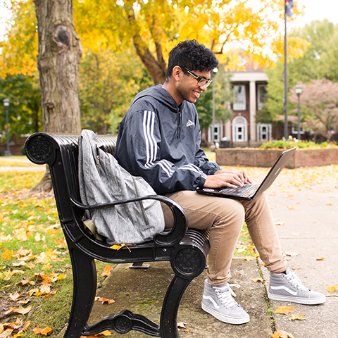 Student studies on browning lawn
