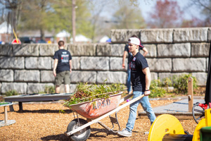Student pushing a wheelbarrow 
