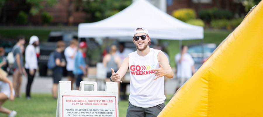 Student by the inflatable slide during Go Weekend