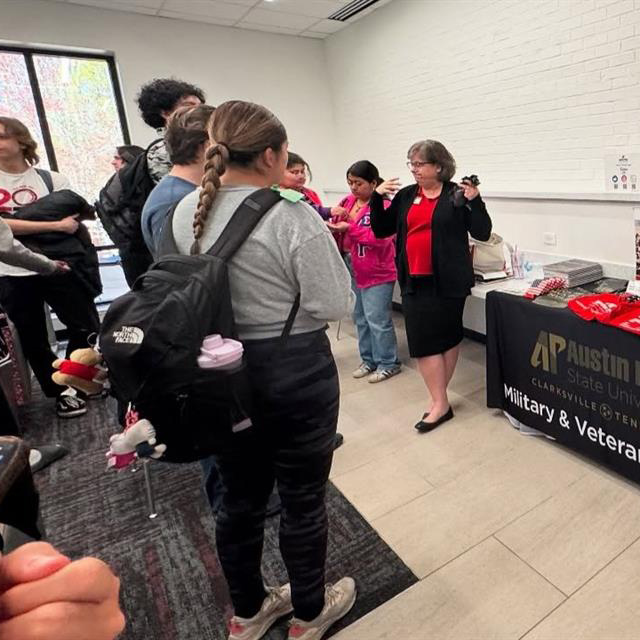 Students listening to a staff member talk about campus resources.