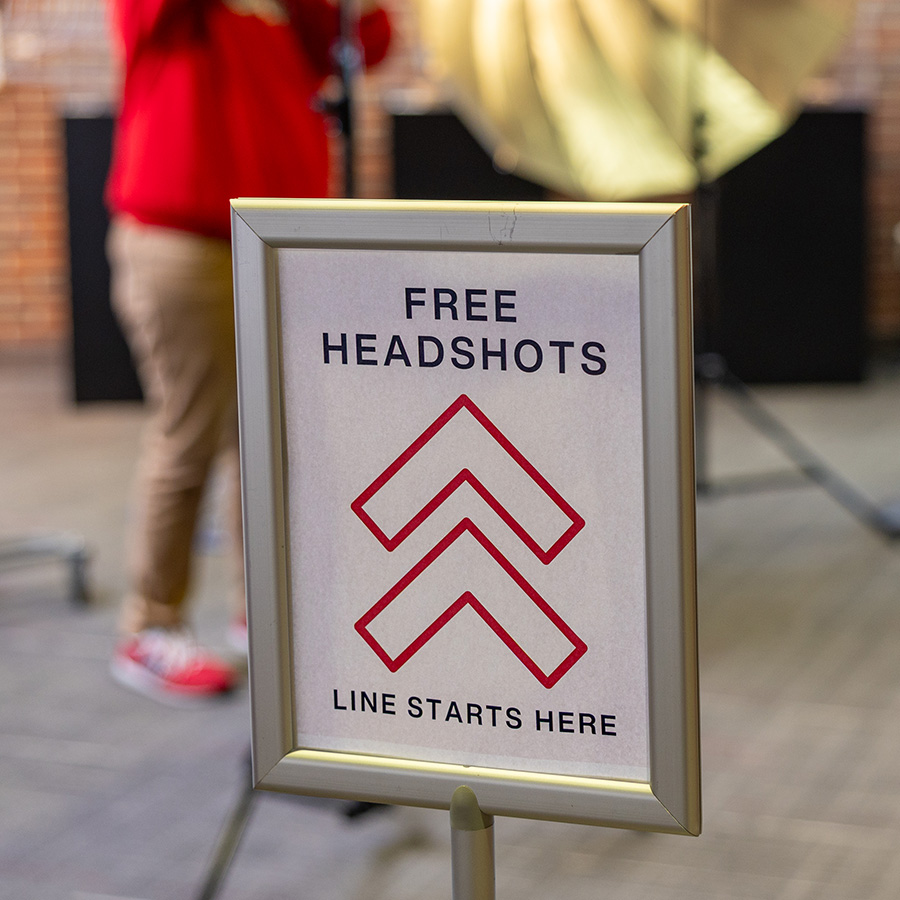 A sign that reads "Free Headshots" during a student career fair.