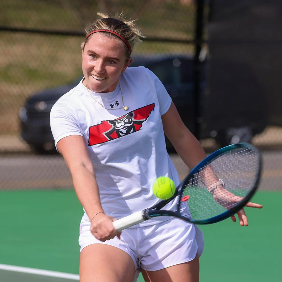 Women's tennis player hitting the ball with racket.