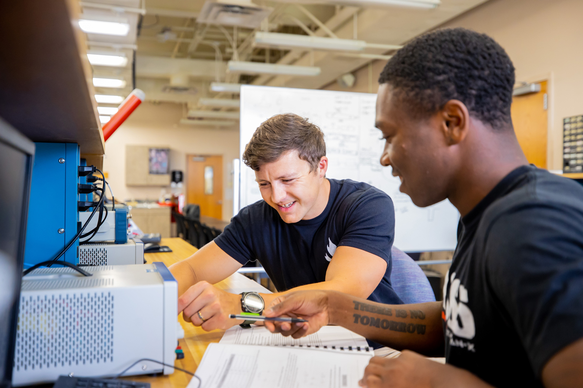 Students working together on equipment in the classroom