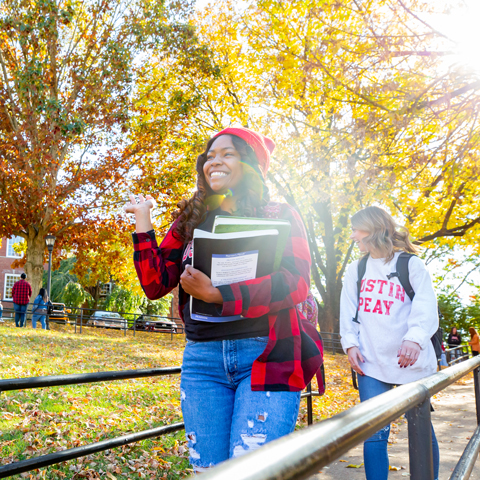 Students walking on campus on a beautiful fall day