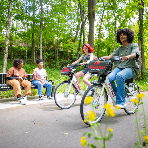Students riding bicycles on the greenway