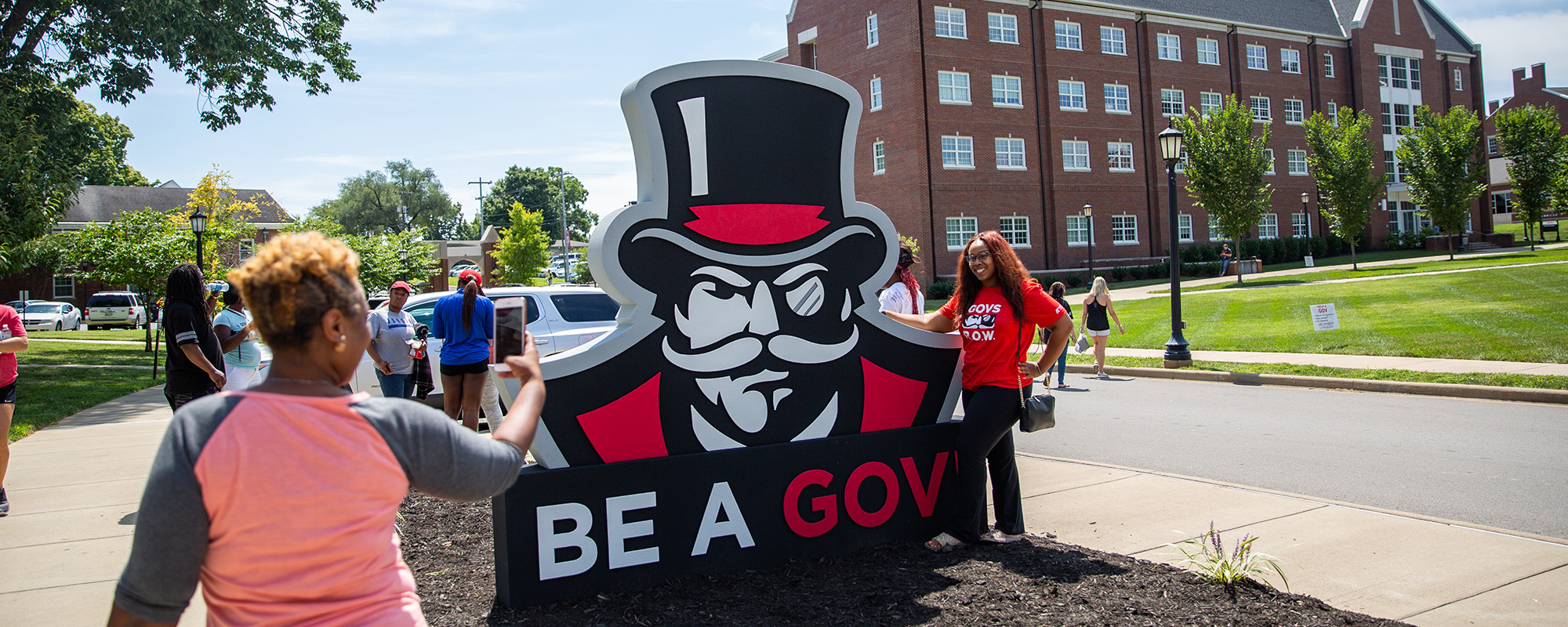 Student poses for photo with Be A Gov sign