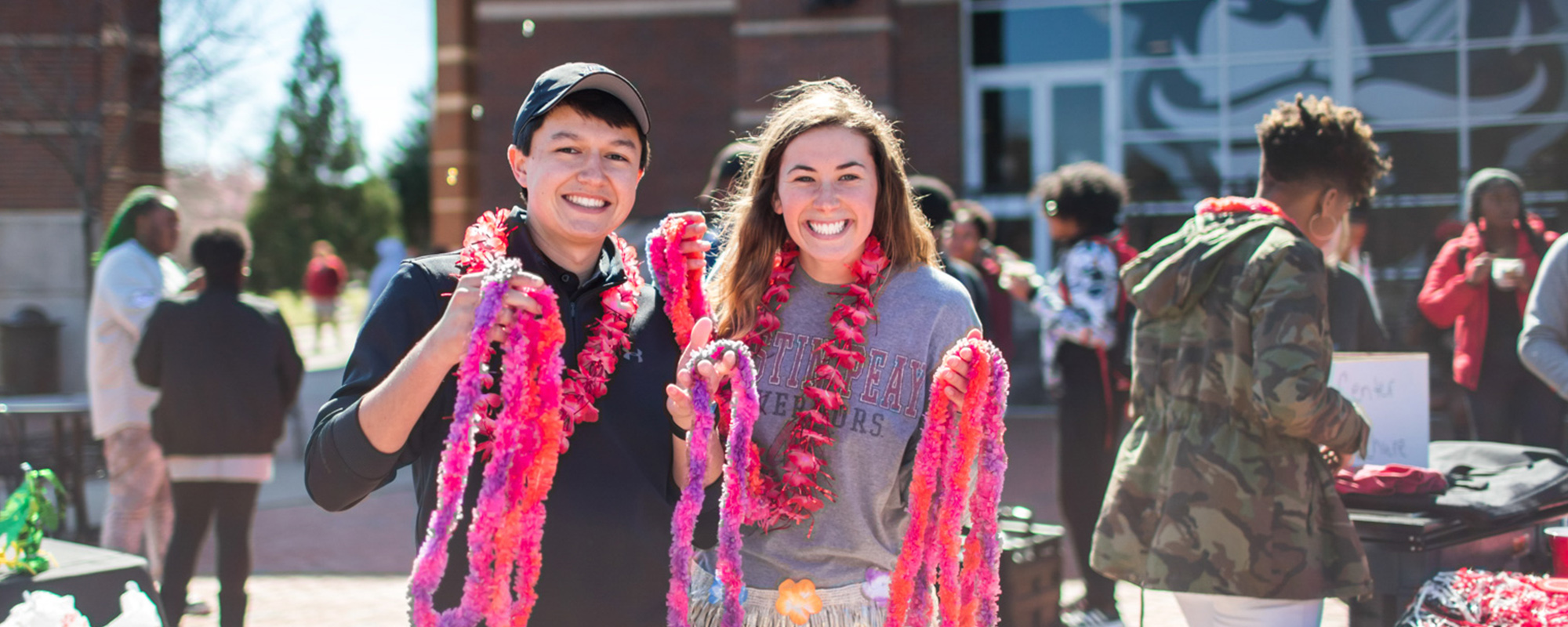 Students hold leis at First Friday