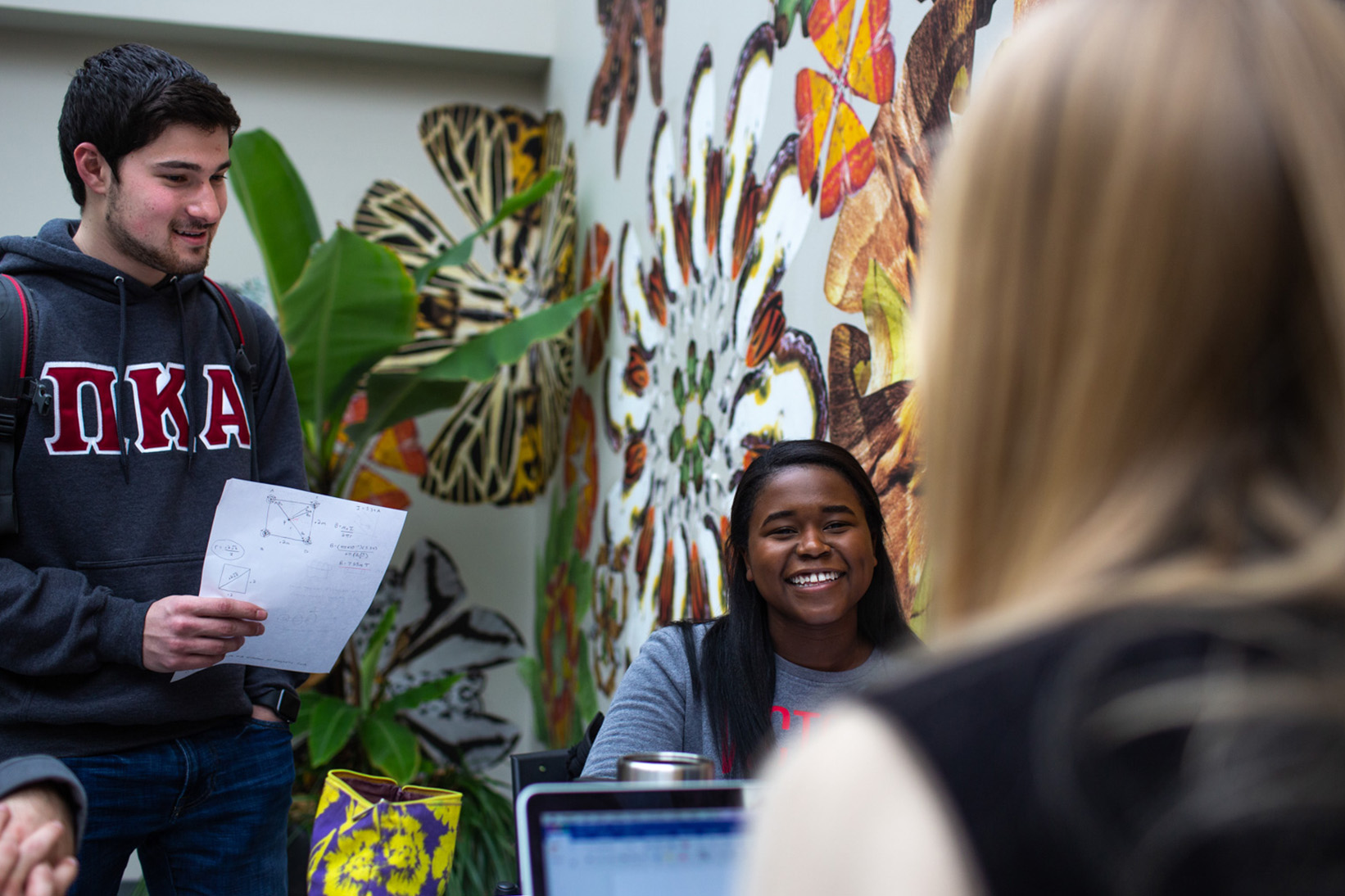 Students study with mural in background