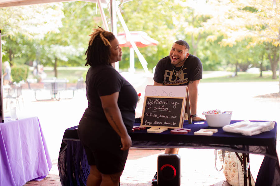 Public Relations major Karlos Clegg talks with visitors to First Friday on Friday, September 2. Ally Shemwell | Intern