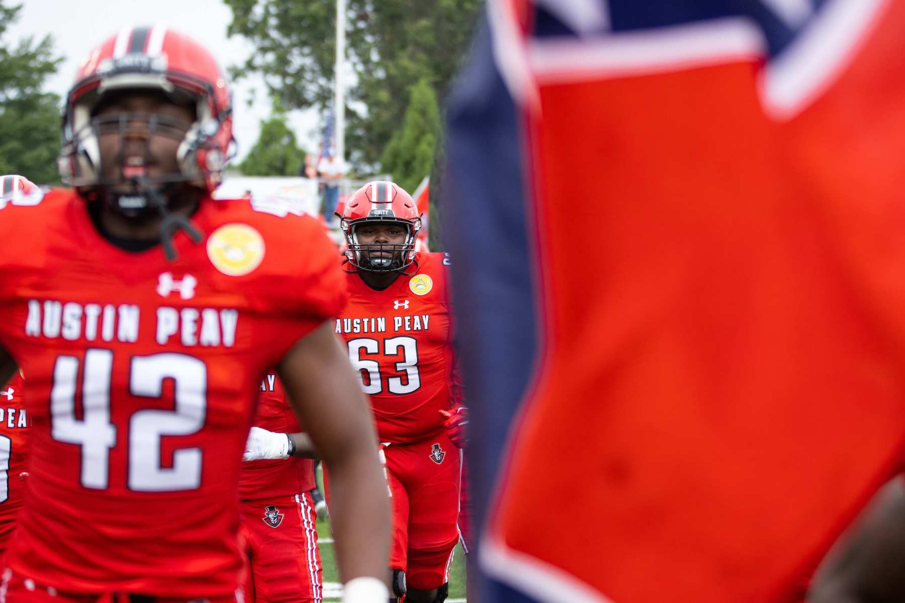 Offensive Lineman Donovan Haslam #63 runs out with the Govs football team, flanked by the Tennessee state flag on Saturday, Sept. 10. The team shut out Mississippi Valley State University 41-0. Sean McCully University Photography and Videography Coordinator