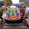 Team moving scupture to end of trailer.