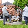 The team manually positioning the main sculpture frame.