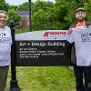 The artists celebrating a successful day of sculpture installations outside the Art + Design Building.