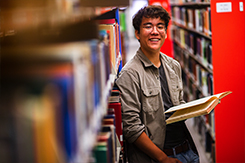 Student reads book in Woodward Library