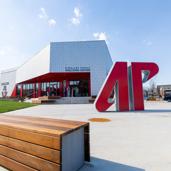 picture of the welcome center front doors showing the large AP statue out front. 