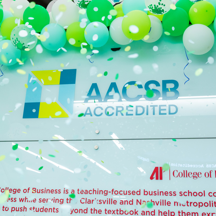AACSB logo surrounding by balloons and confetti at the celebration. 
