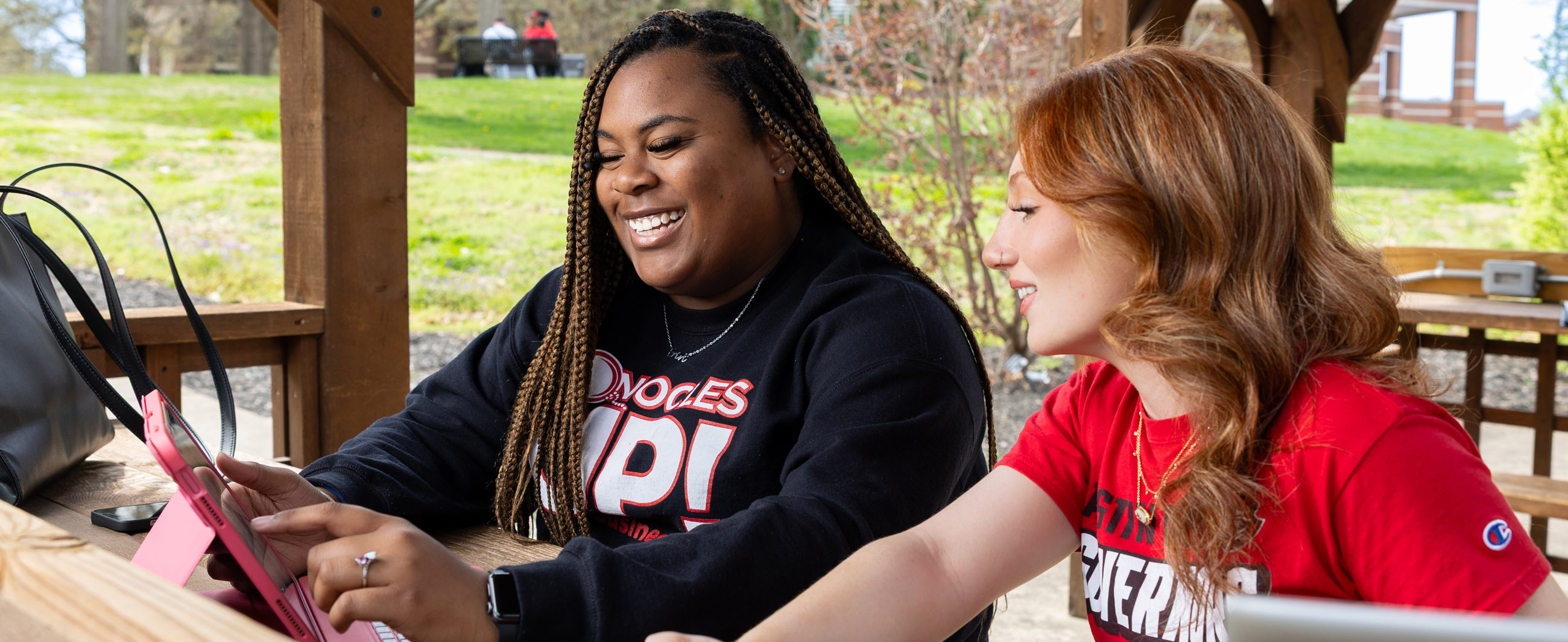 Students talking in a pavilion on campus between classes.