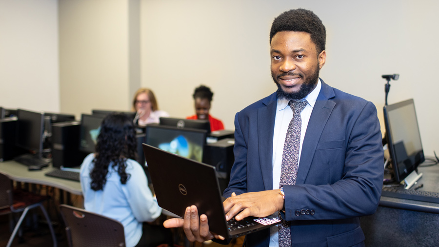 Student with laptop in computer lab