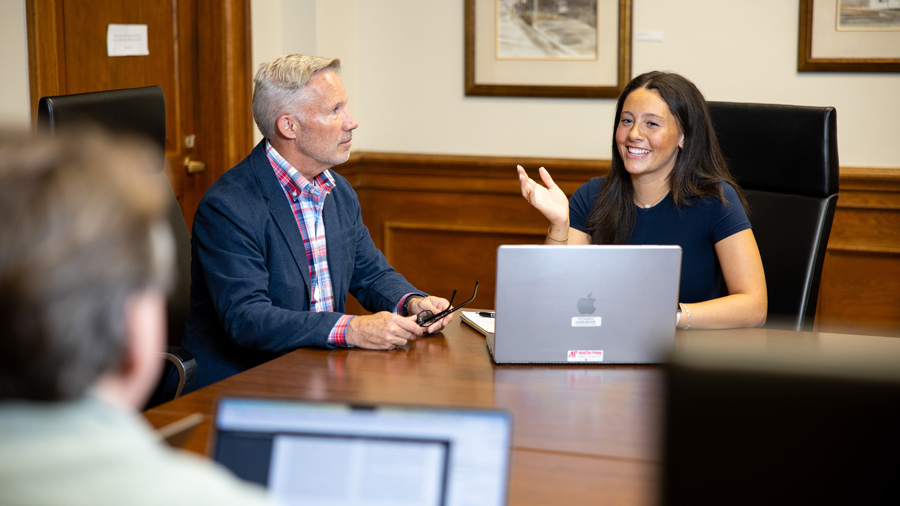 student and professor presenting research 