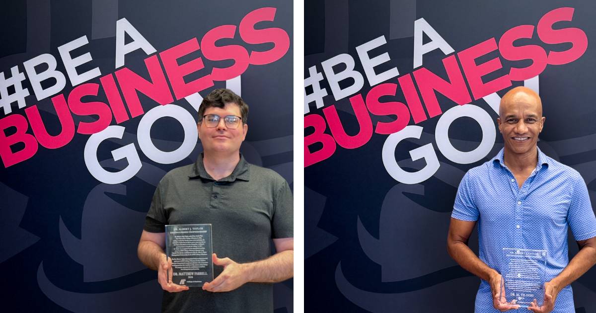 A.J. Taylor Award winners, Matt Farrell and Al Tilooby posing with their awards in front of a black backdrop that says be a business gov.