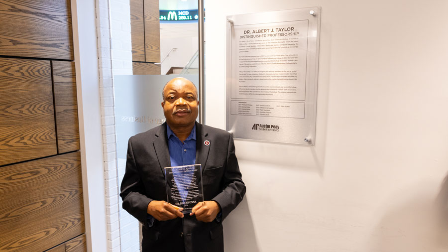 Dr. Dong Nyonna holding his award