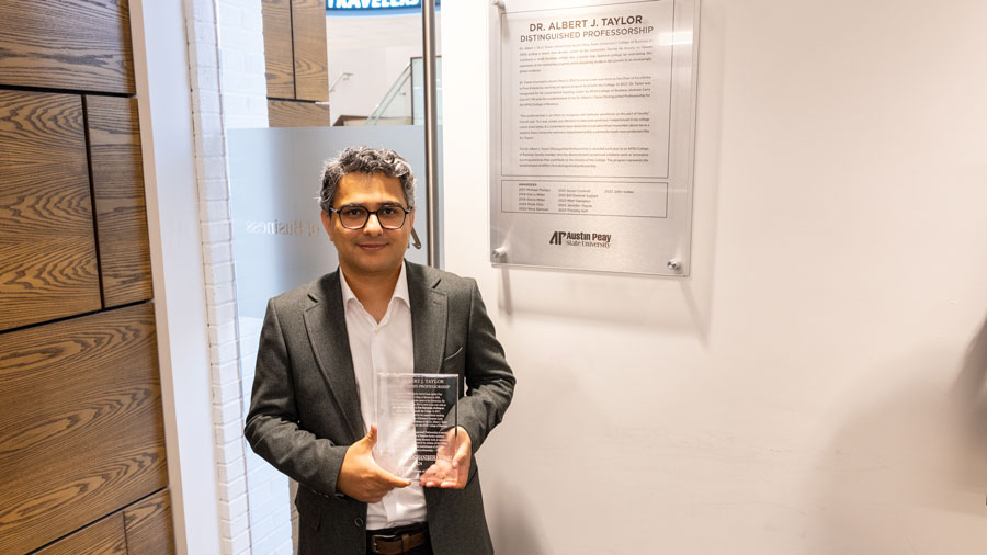 Dr. Hamid Noghanibehambari holding his award