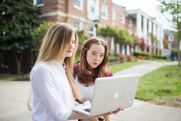 Students outdoors on laptop