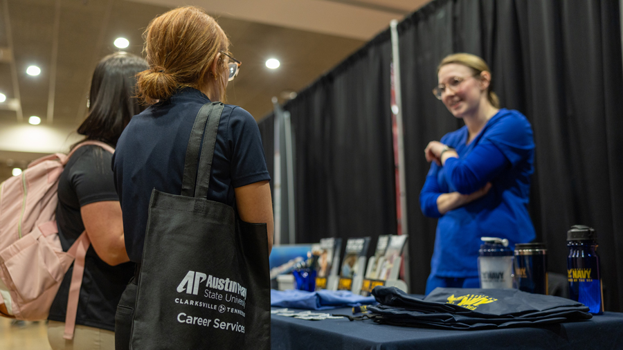 Students talking with a recruiter at a career fair