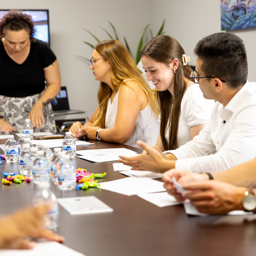 Students sitting around a conference table being briefed about the internship program
