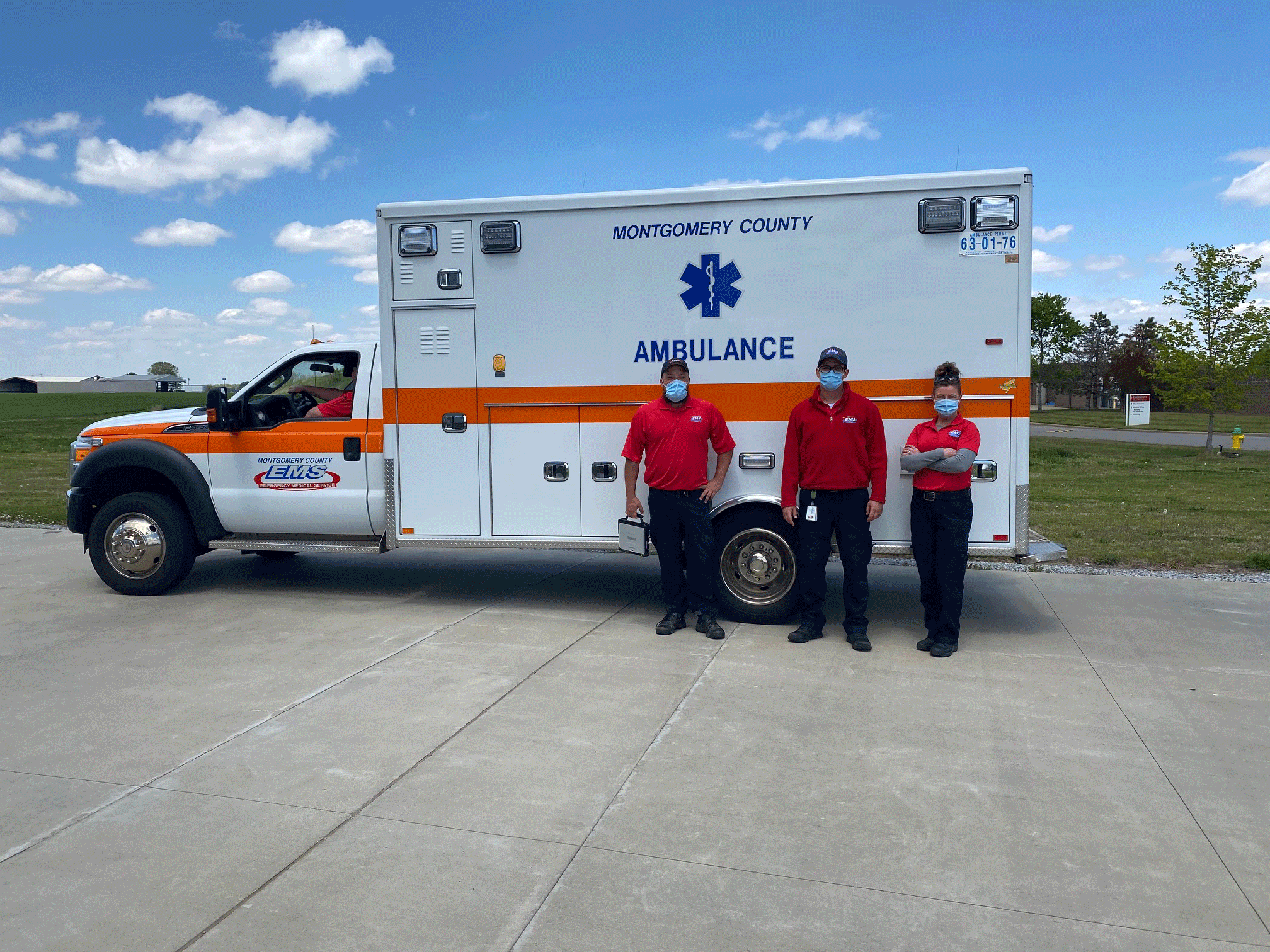EMTs in front of ambulance