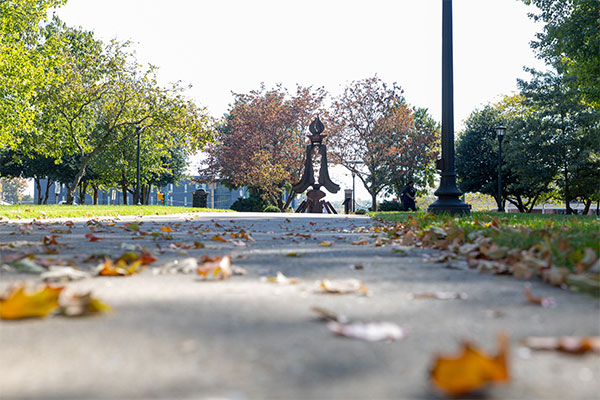 low shot of the Browning quad on a fall day. Leaves are scattered about over the sidwalks.