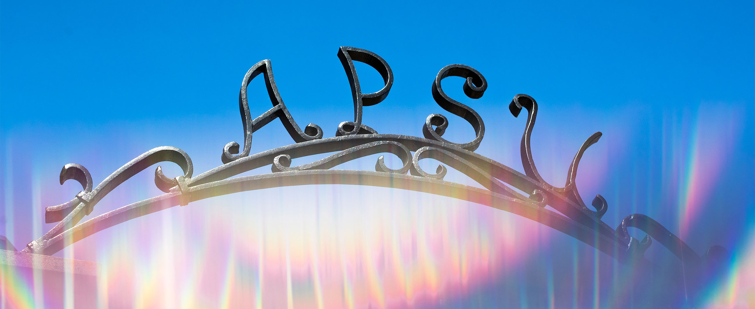 Wrought iron archway with the letters APSU spelled out by the metal. 