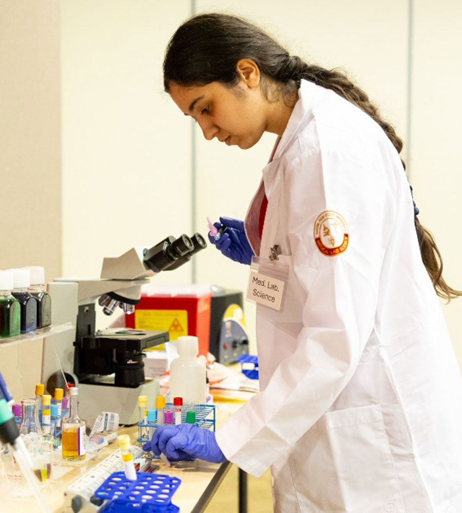 Student testing samples in lab