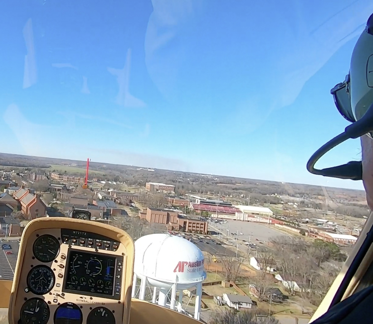 Charlie Weigandt pilots rotor wing helicopter over APSU water tower
