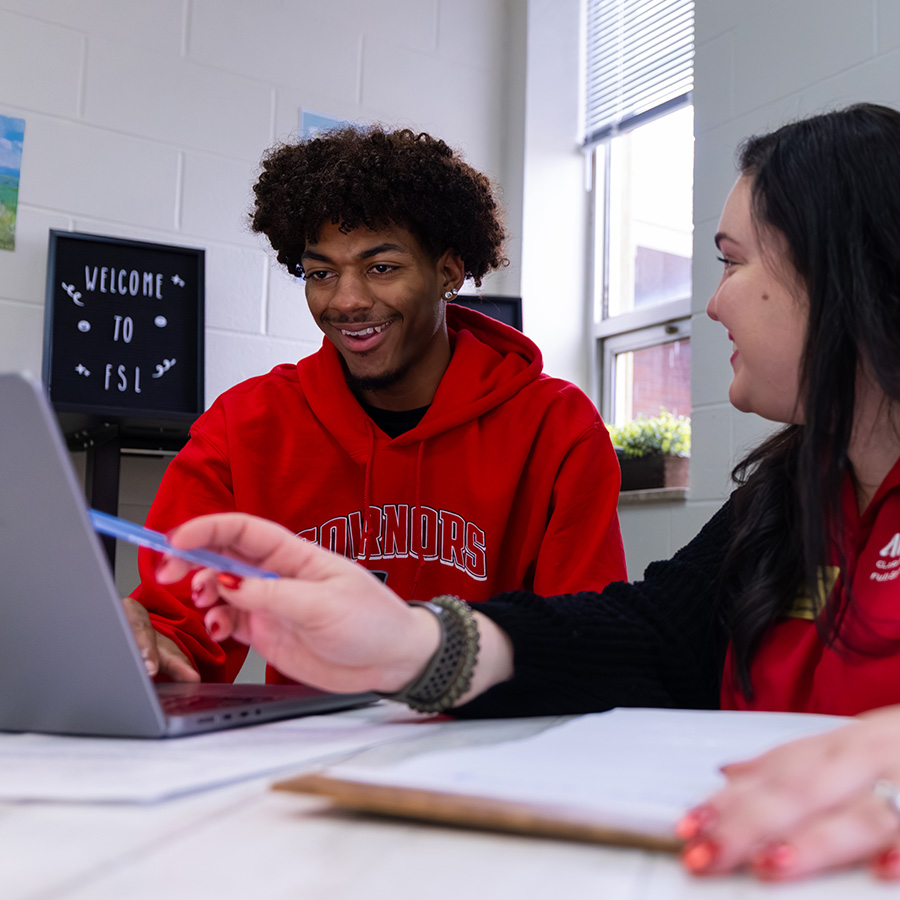 A peer student tutoring another student in the Learning Lounge.