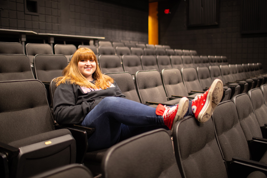 Alyssa Amos sitting in an auditorium.