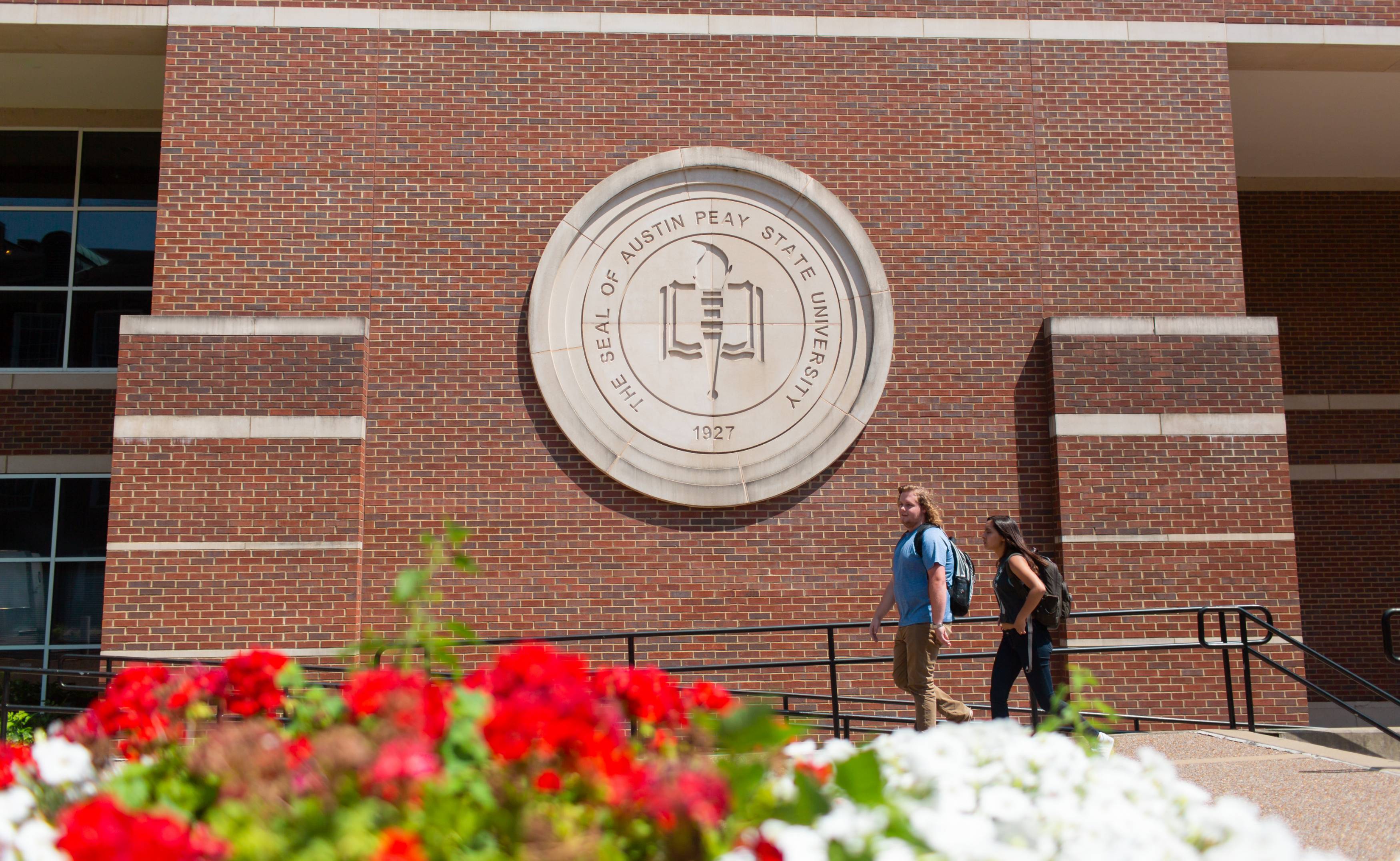 Students walking in front of APSU seal