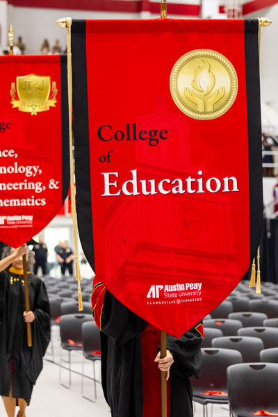 College of Education Gafalon banner being carried into the commencement ceremony.