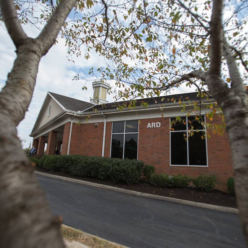A view of APSU's Ard building through some tree