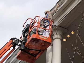 Maintenance on scaffold painting building