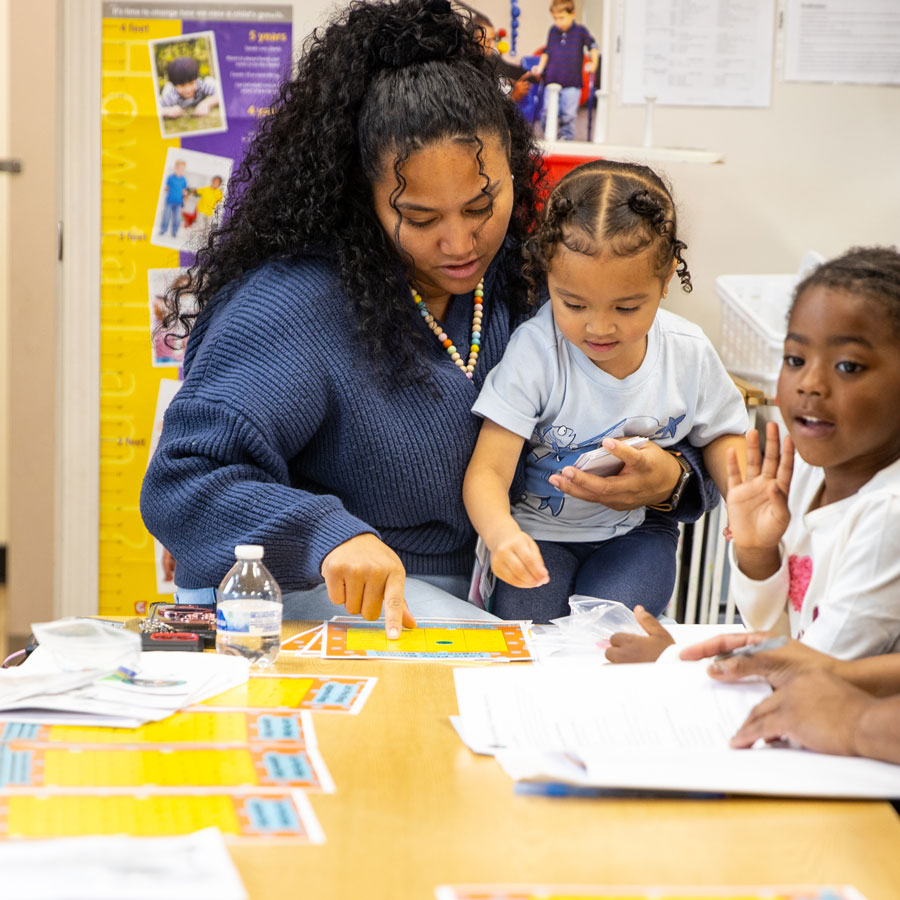 Adult helping a child learn to read.