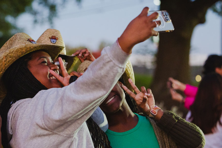 Students taking a group selfie at the Bonfire.