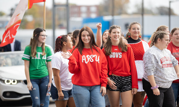 Students waling in the homecoming parade to represent their Sorority. 