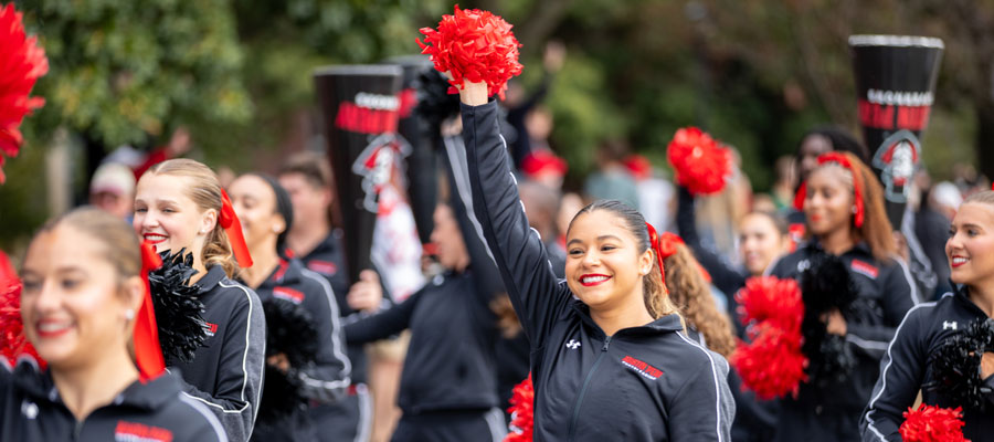 Cheerleaders walking in the homcoming parade.