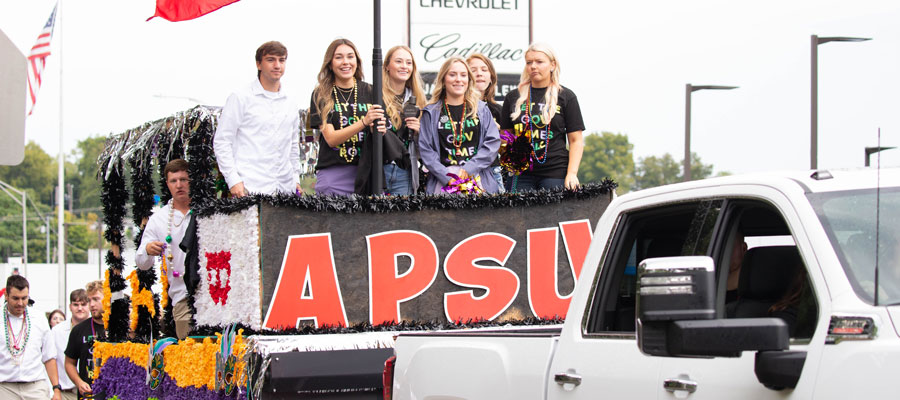 Students riding on a homecoming float.
