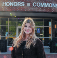 Picture of Ella Holland in front of the Honors Commons
