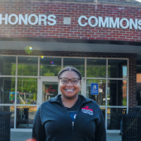 Picture of Logan Wallace in front of the Honors Commons