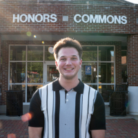 Image of Tyler Rose in front of the Honors Commons